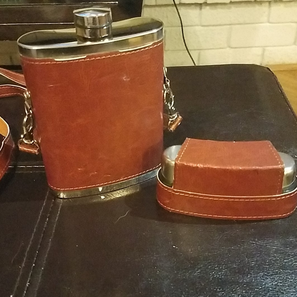 Flask with shot glasses included.